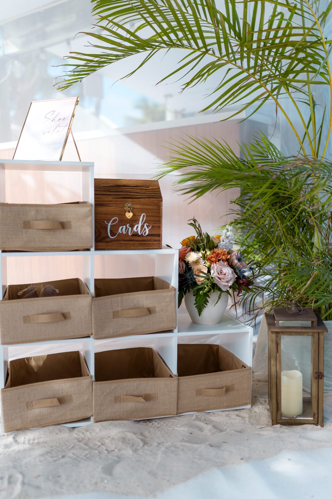 The scene shows a card display area at Avila Beach Hotel, featuring a wooden box labeled "Cards," decorative flowers, and several empty storage bins