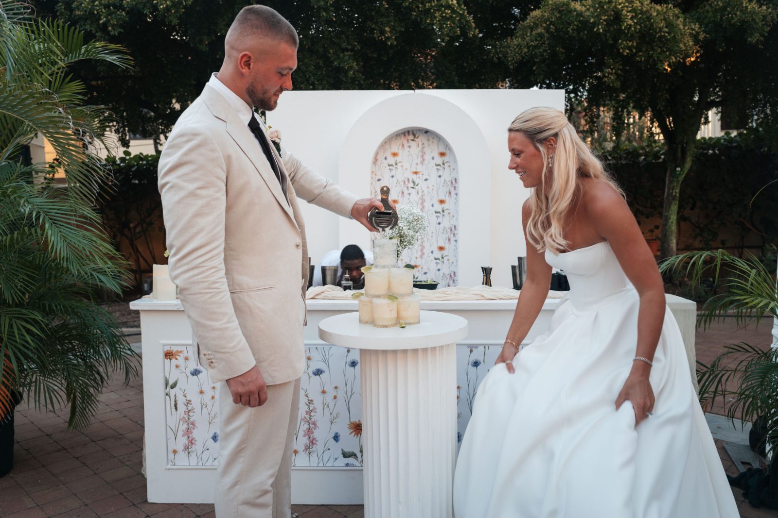 Cailey and Noel are performing a unity ceremony at their wedding reception, set at Avila Beach Hotel in Curaçao, with a decorated table in the background