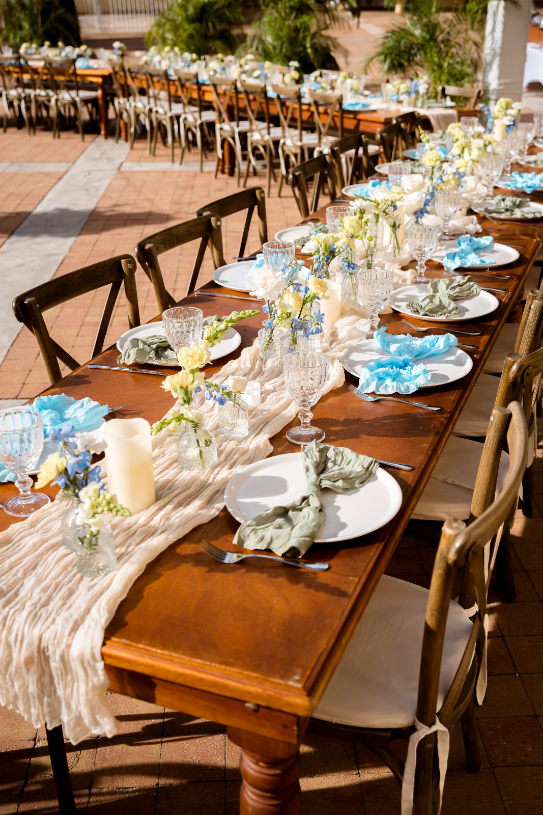 Cailey and Noel's wedding reception table is set with elegant tableware and floral arrangements at Avila Beach Hotel in Curaçao