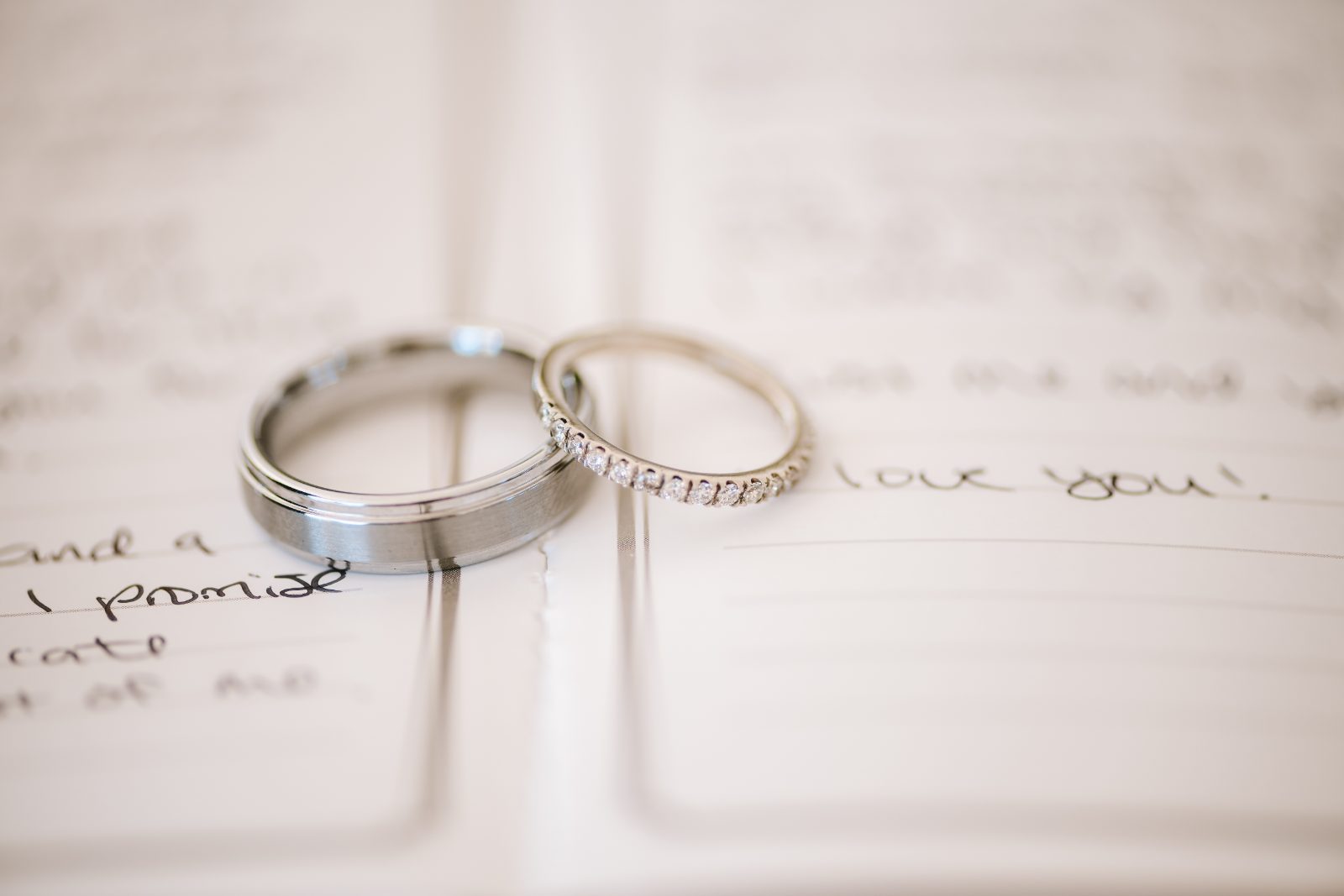 The wedding rings of Christine and Jesse are displayed on an open notebook with handwritten notes at a private villa in Curaçao