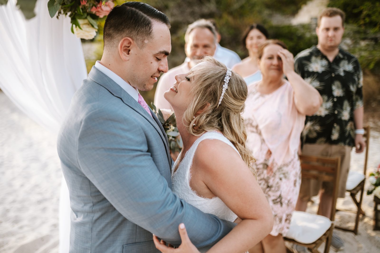 Christine and Jesse are exchanging vows at their wedding ceremony at a private villa in Curaçao, surrounded by family and friends