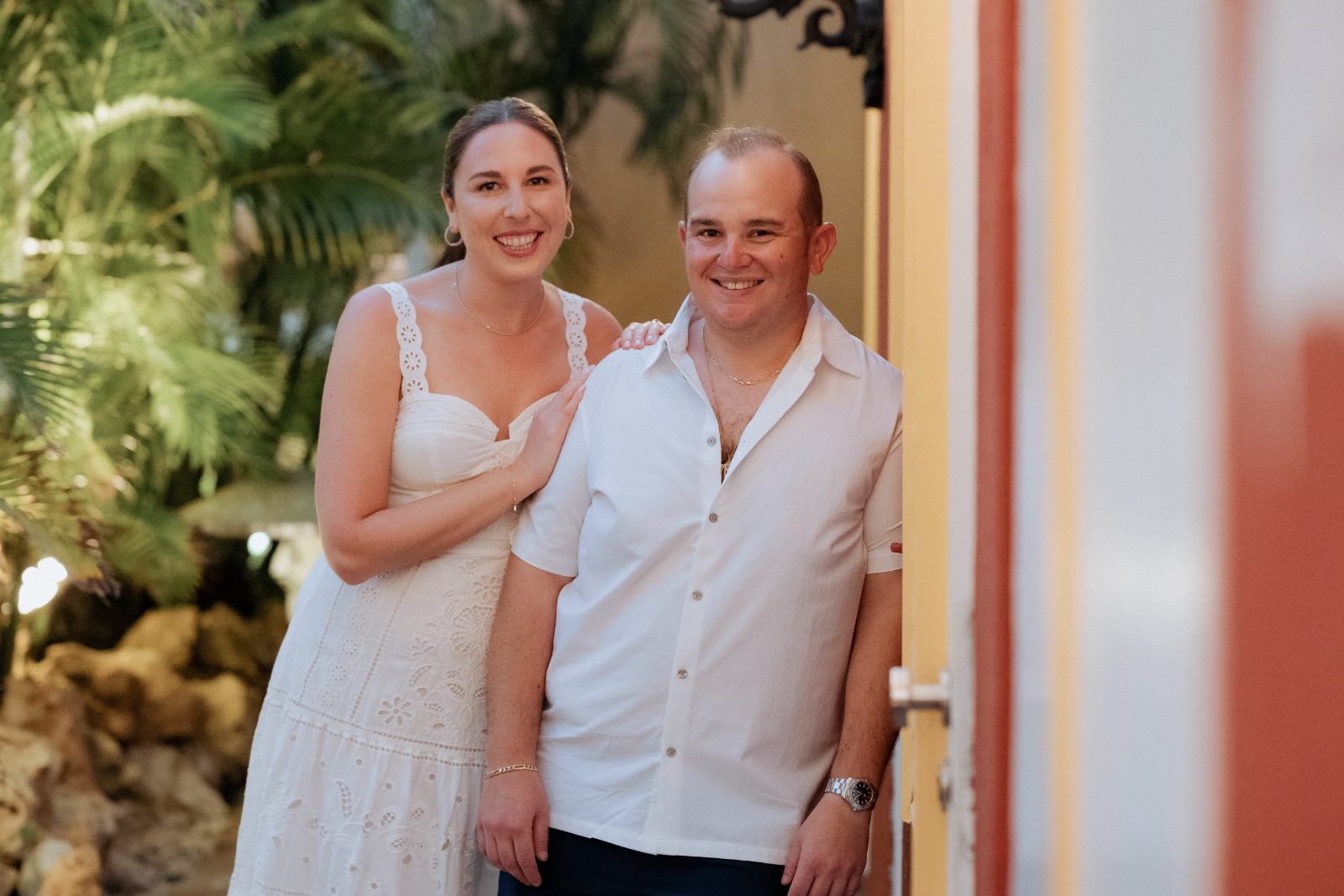 Frannie and Dustin stand together, smiling, at Grand Café ‘Gouverneur de Rouville’ during their welcome