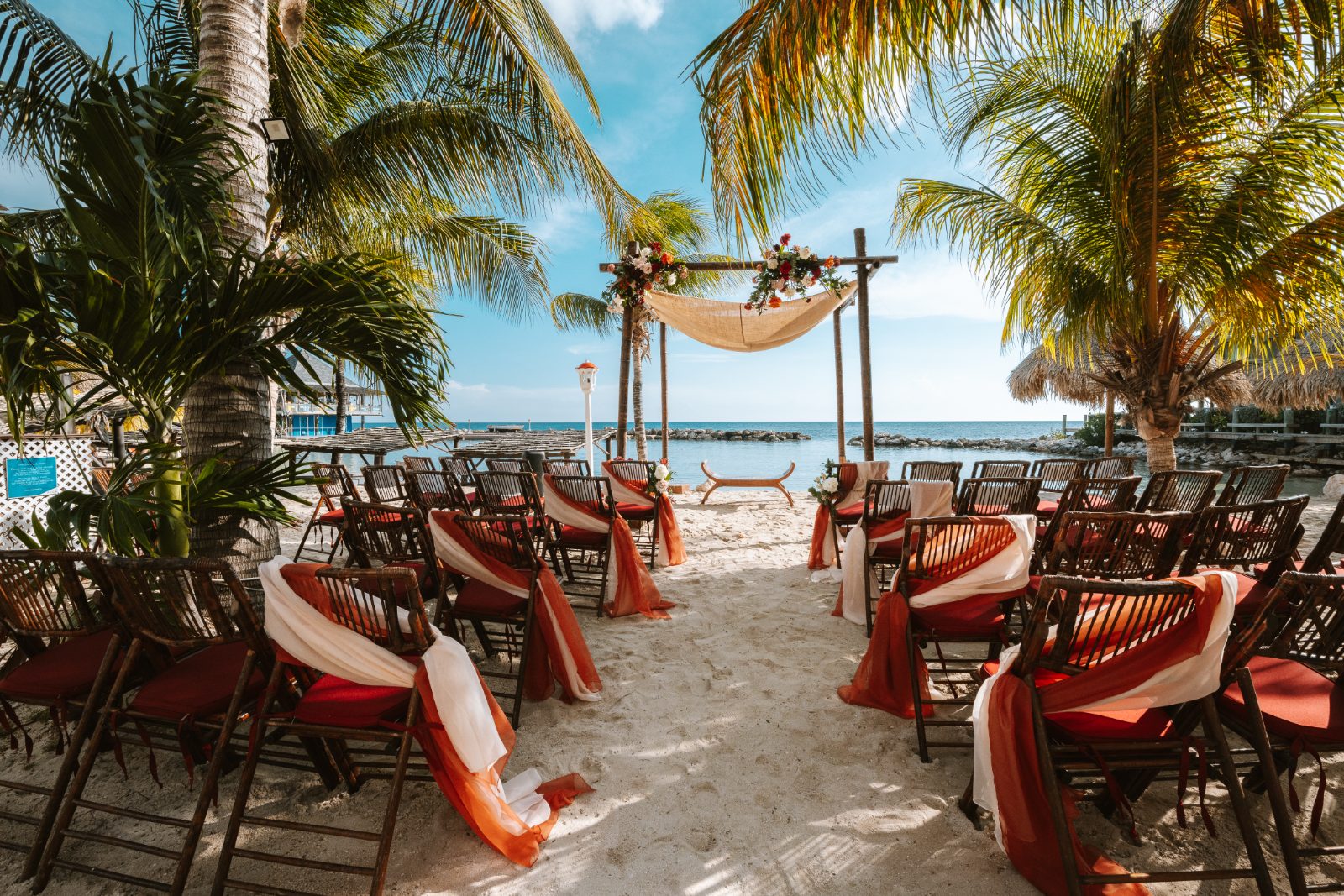Gaëlle and Jeroen are getting married on the beach at Avila Beach Hotel in Curaçao, surrounded by decorated chairs and palm trees