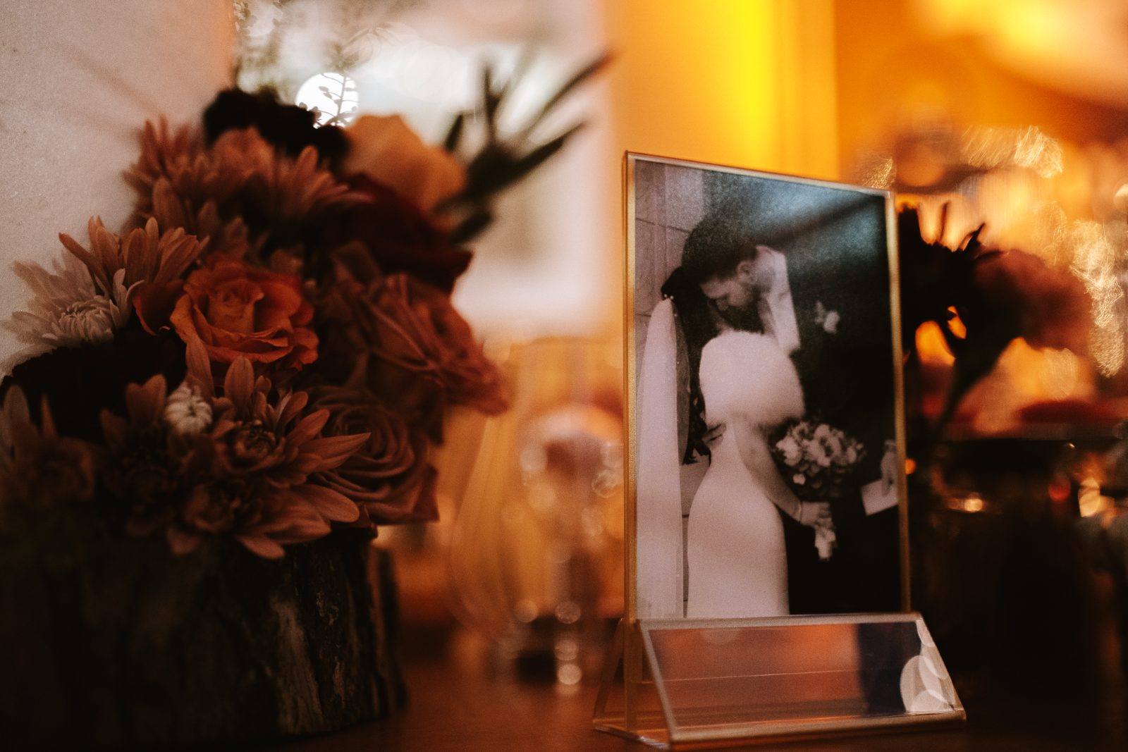 Gaëlle and Jeroen's wedding photograph is displayed alongside decorative flowers at their reception in the Avila Beach Hotel, Curaçao