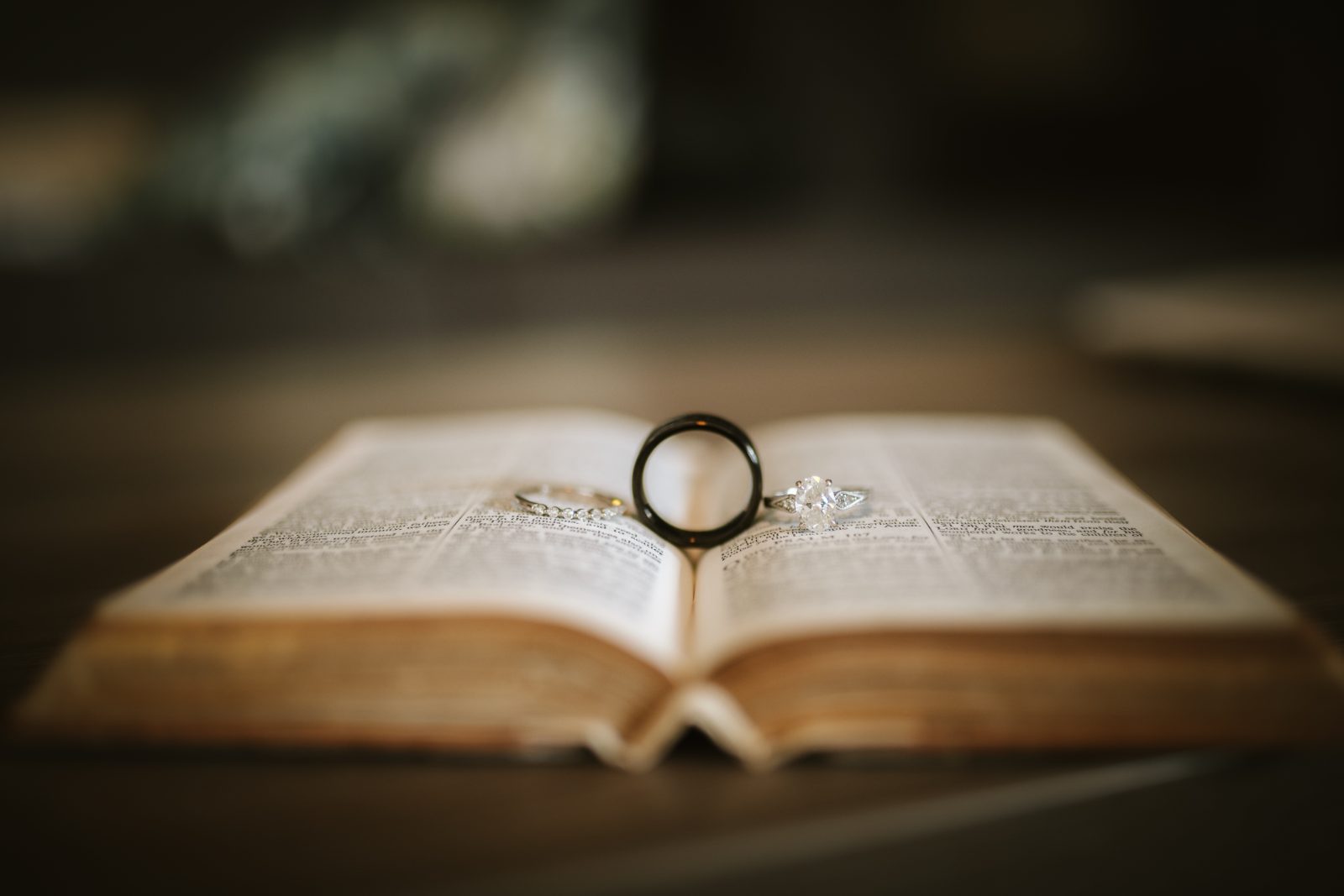 Jennifer and Weston’s wedding rings are placed on an open book at Karakter in Curaçao
