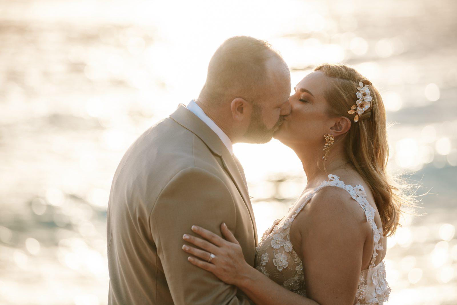 Jennifer and Weston kiss by the water at Karakter in Curaçao during their wedding ceremony