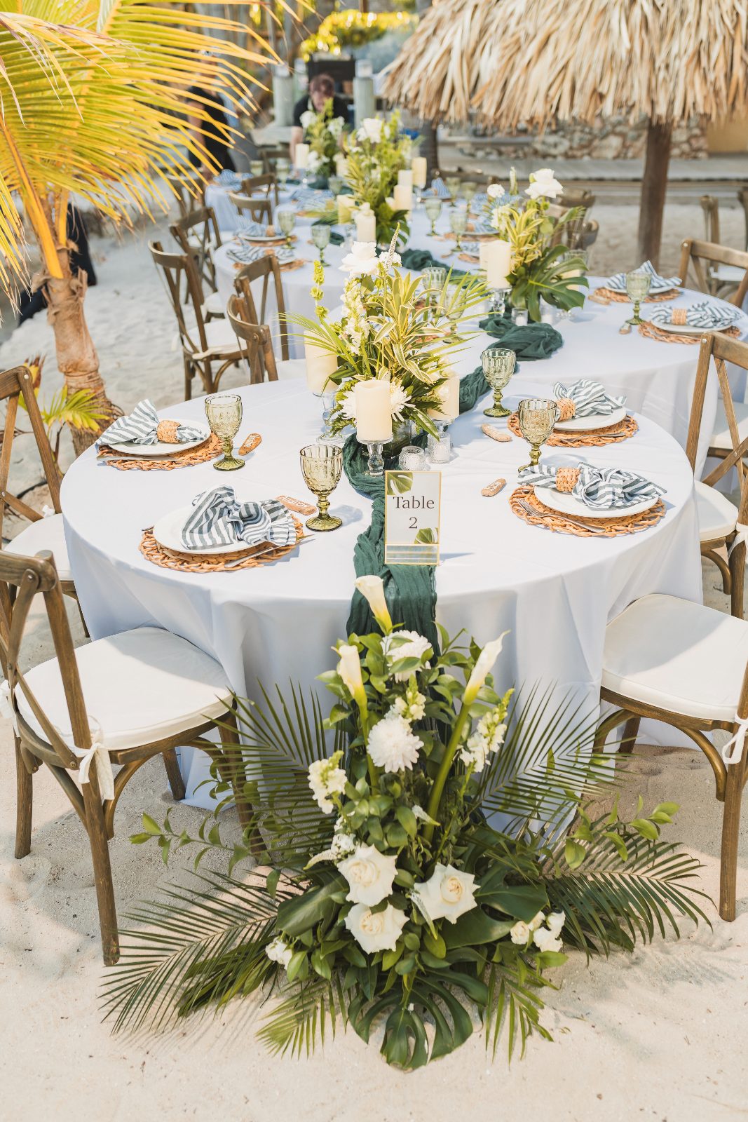 Jessica and Bogdan's wedding reception is set at the beachside venue of Avila Beach Hotel, featuring a decorated table with flowers and candles