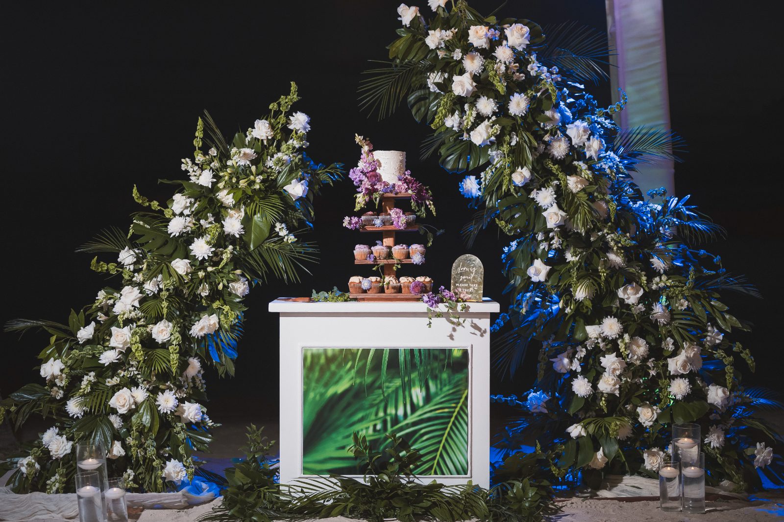 Jessica and Bogdan's wedding ceremony takes place at the Avila Beach Hotel in Curaçao, featuring a decorated altar with flowers and a dessert display