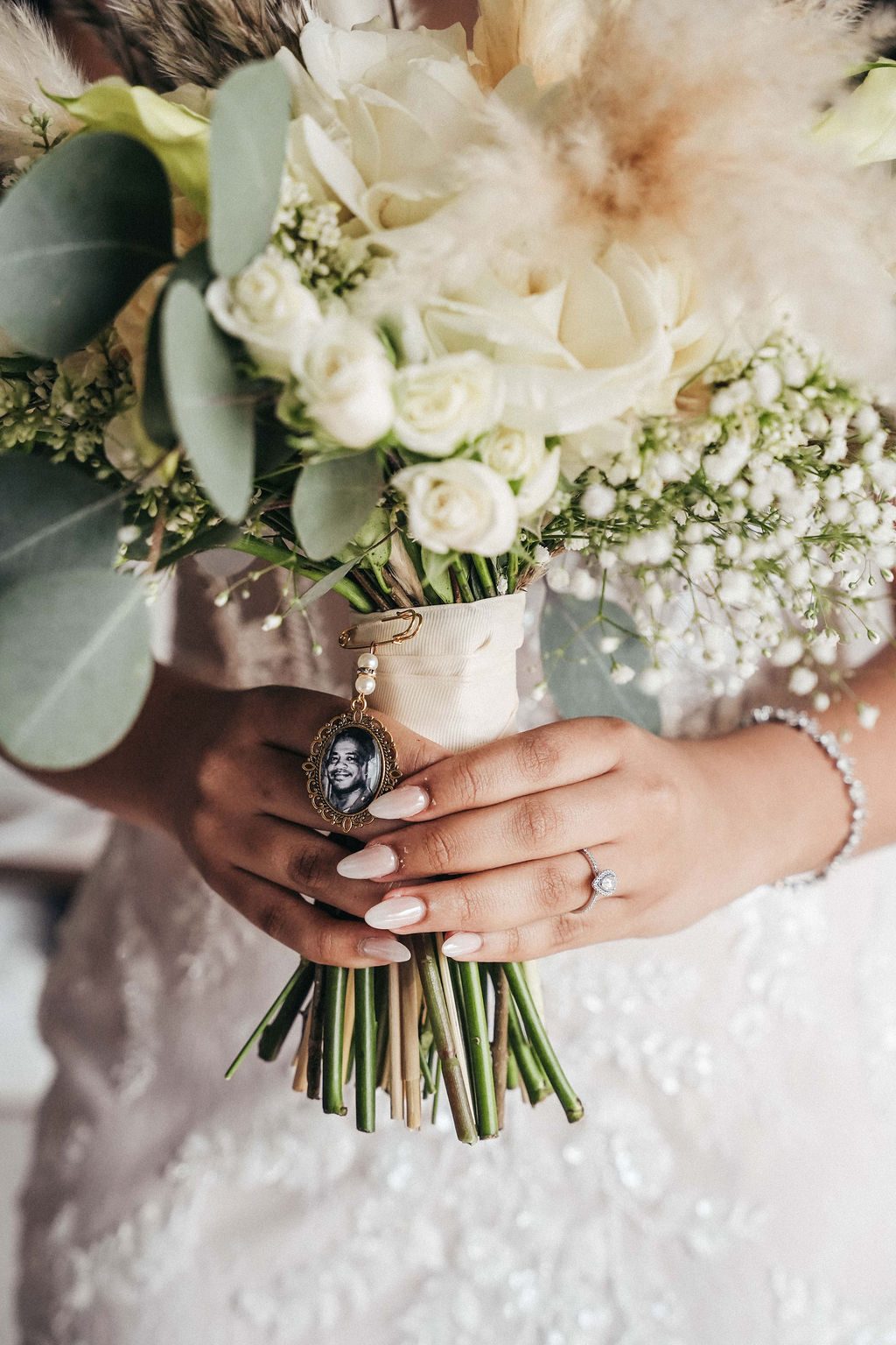 Kayla holds a bouquet of flowers at Avila Beach Hotel, featuring a pendant with a photograph attached to it