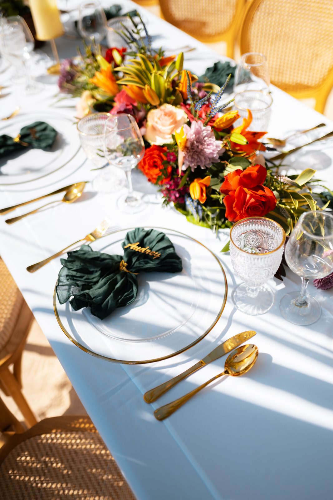 The wedding table is set with elegant place settings, a floral centerpiece, and glassware at the Avila Beach Hotel in Curaçao